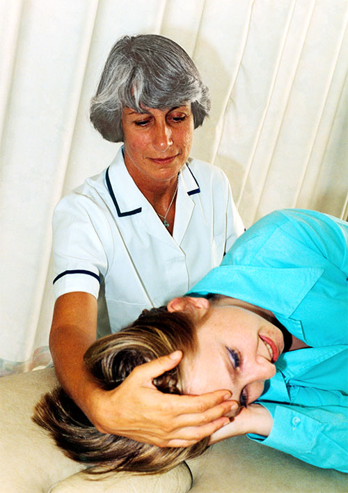 A photo show Myra carrying out a physiotherapy treatment on a patient