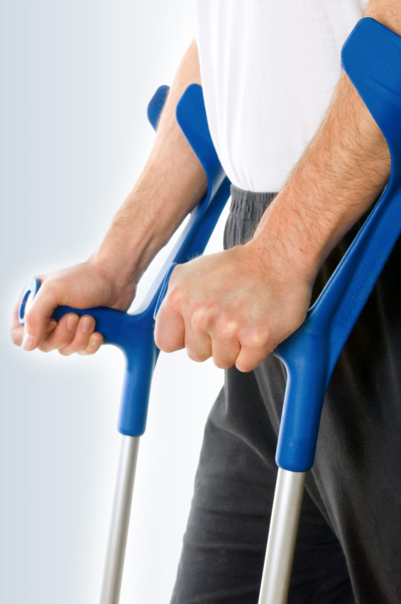 a photo of a mans arms holding crutches to support walking